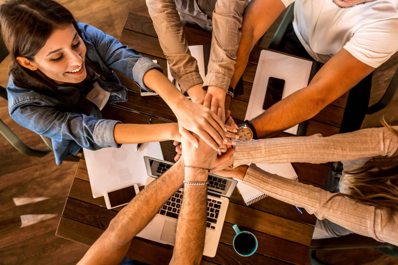 Group of friends studying together and making a high five